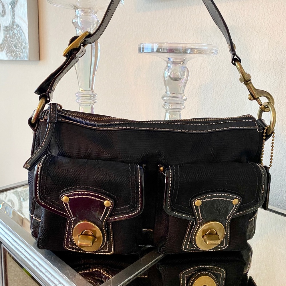 Black Coach handbag. With brushed gold hardware .